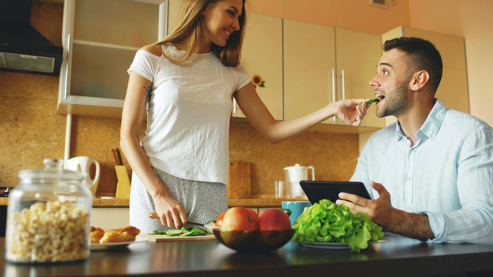 A couple preparing food together in a modern kitchen.